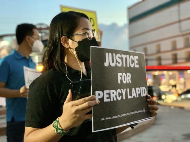 Groups stage an indignation rally along Timog Avenue in Quezon City to denounce the killing of veteran broadcaster Percy Lapid.