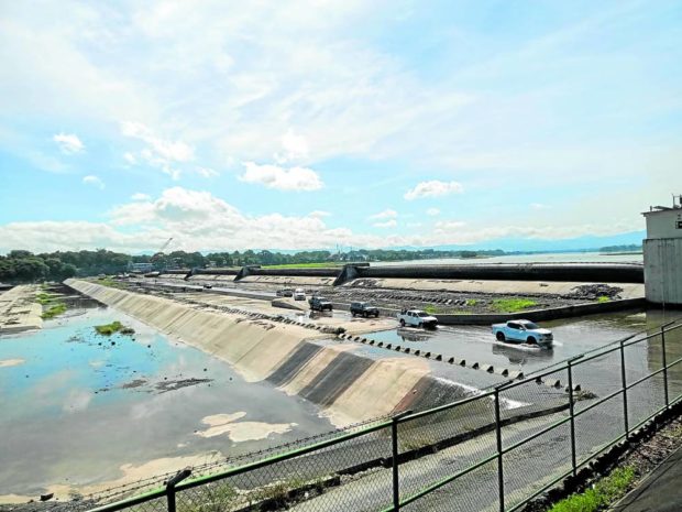 UP CLOSE In this photo taken in May 2020, a convoy of vehicles brings a team from the Bulacan provincial government to Bustos Dam to inspect its rubber gates. —CARMELA REYES-ESTROPE