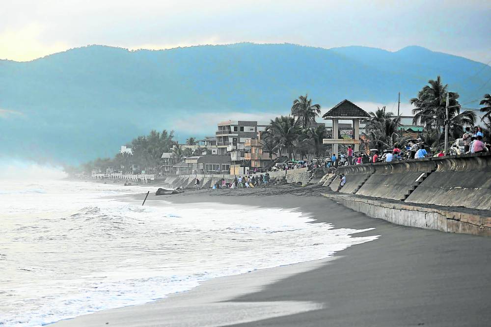 Tourists and residents enjoy the sunrise on Sabang Beach in Baler, Aurora reward slay