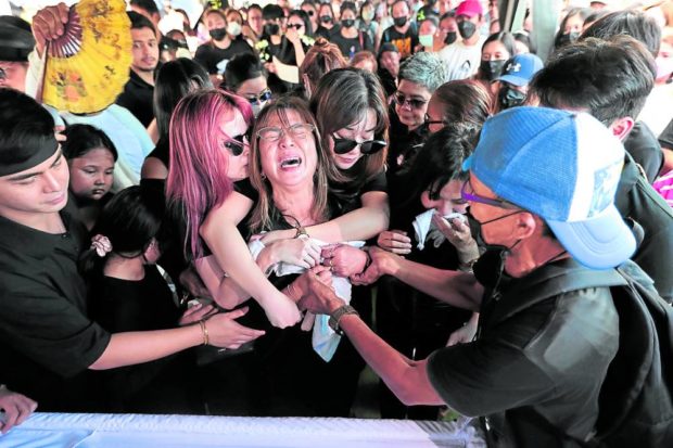 The wife and children of slain commentator Percival “Percy Lapid” Mabasa grieve as he is laid to rest on Sunday. —GRIG C. MONTEGRANDE. STORY: Percy Lapid burial: ‘May his death be like the planting of a seed’