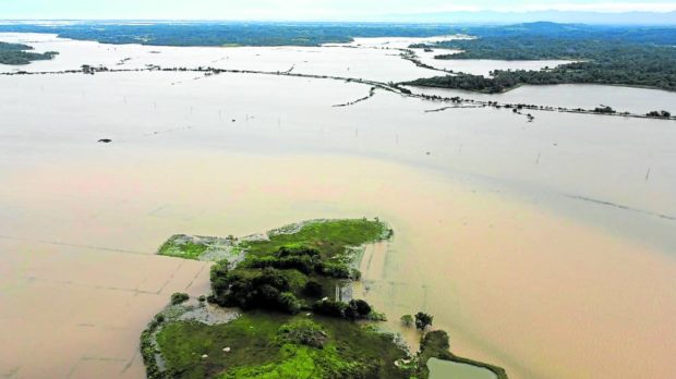 DELUGE Floodwater inundates a vast area, mostly farmlands, in Allacapan town, Cagayan province, in this aerial photo taken on Sunday morning as Typhoon “Neneng” (international name: Nesat) worsened floods caused by last week’s Tropical Depression “Maymay.” —PHOTO COURTESY OF ALLACAPAN MAYOR HARRY FLORIDA