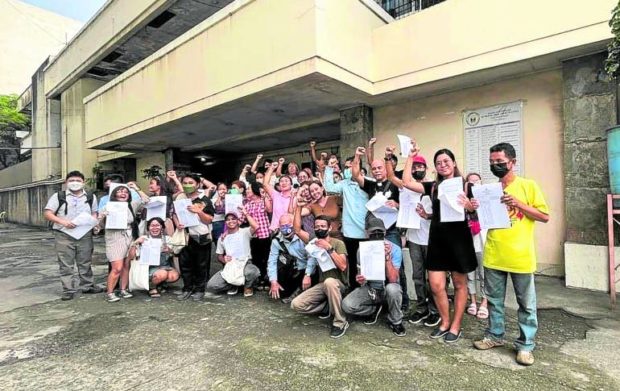 Activists collectively known as “Iloilo 42” gather for a photo opportunity after they were acquitted on Oct. 19 by the Municipal Trial Court in Cities Branch 7 in Iloilo City