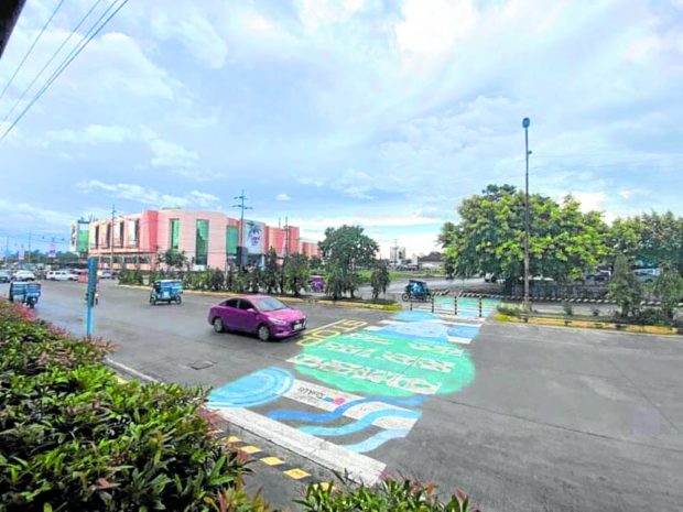 HAPPY COLORS The painted pedestrian lane in Tagbilaran City, in this photo taken on Oct. 6, serves to brighten the city and uplift Boholanos’ morale as the province recovers from the physical and financial losses brought by Supertyphoon “Odette” (international name: Rai) in December 2021. —LEO UDTOHAN