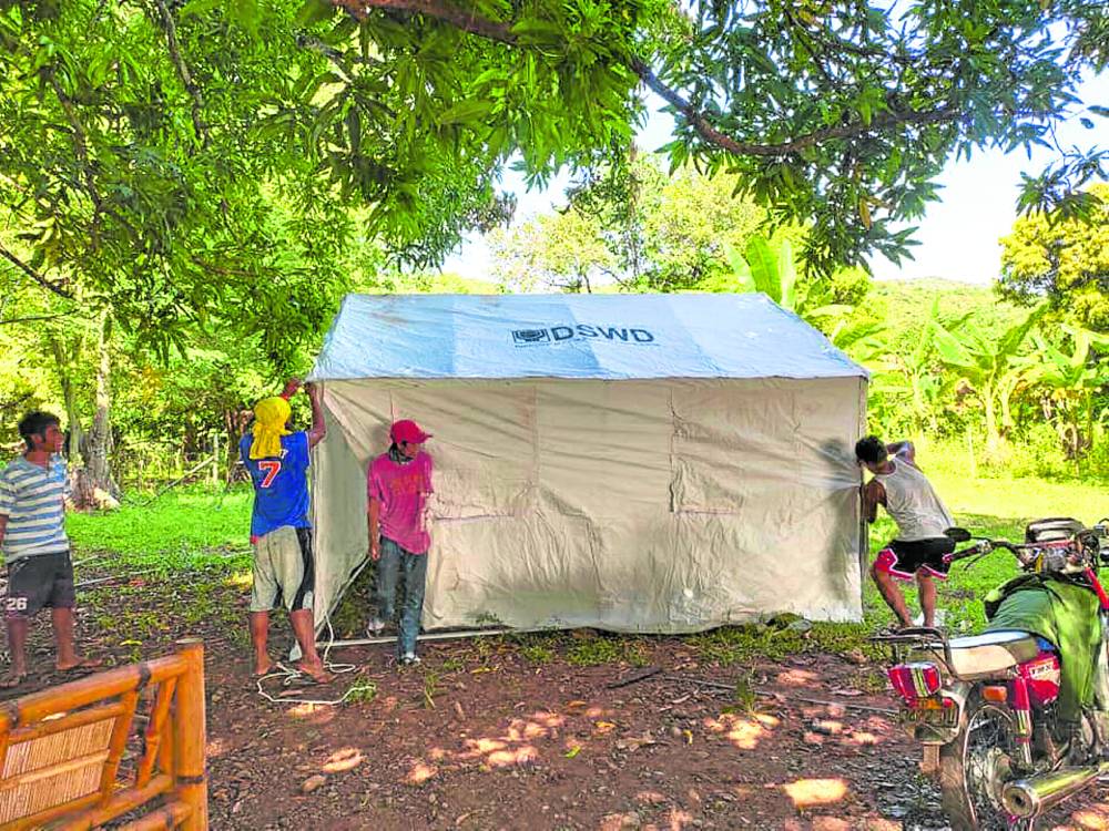 Department of Social Welfare and Development workers in Lagayan, Abra, start putting up tents for families displaced by Tuesday’s strong earthquake