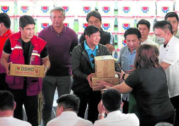 LOOK WHO’S HERE President Marcos, accompanied by Social Welfare Secretary Erwin Tulfo and local officials, on Monday hands out relief goods to residents of Noveleta town in Cavite province, one of several areas hit by floods as Severe Tropical Storm“Paeng” (Nalgae) battered the country over the weekend.