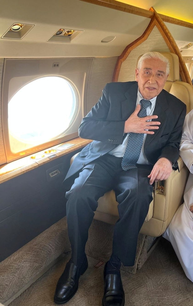 Baquer Namazi gestures prior to takeoff to Muscat, on board airplane in Tehran