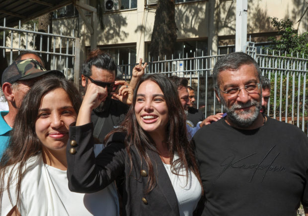 Hafiz, who forced a bank to release her family savings in September, gestures after she was released, outside the Justice Palace in Beirut