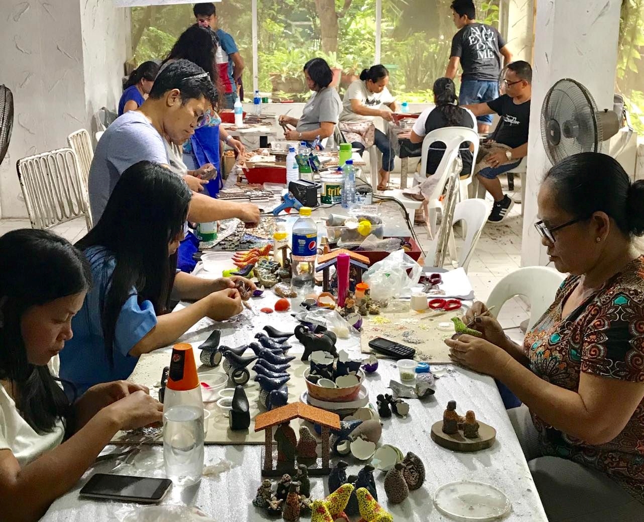 Members of the Negrense Volunteers for Change Foundation make Christmas ornaments that can help feed undernourished children.