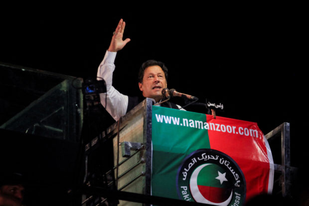 FILE PHOTO: Ousted Pakistani Prime Minister Imran Khan gestures as he addresses supporters during a rally, in Lahore