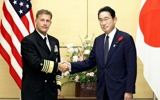 Prime Minister Fumio Kishida shakes hands with U.S. Adm. John Aquilino
