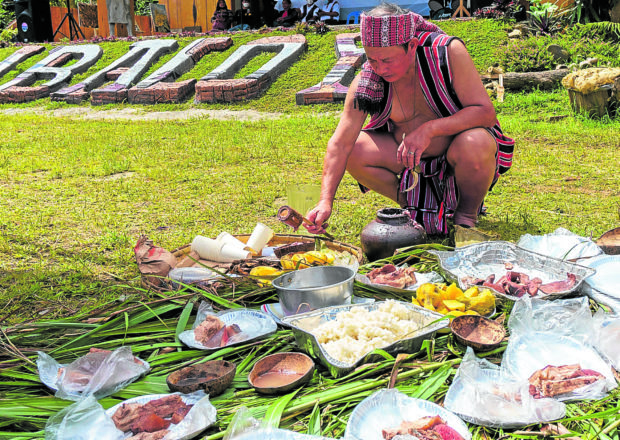 Felix Siplat offers prayers during an Oct. 2 festival that gathered 22 Ibaloy clans at Burnham Park in Baguio. STORY: Retracing Ibaloy heritage in American-built Baguio