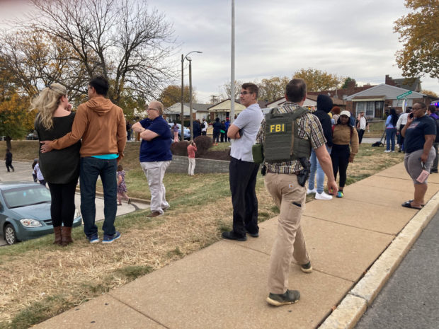 People gather following a shooting at a high school, in St. Louis