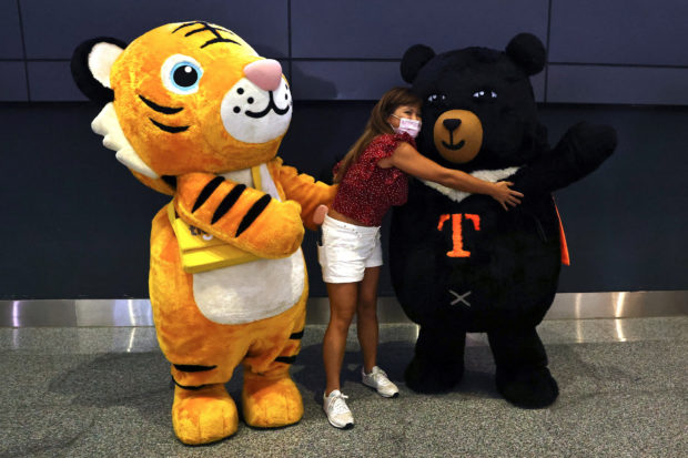 Traveller from Thailand on the first quarantine-free flight to Taiwan poses for a photo at the airport in Taoyuan,