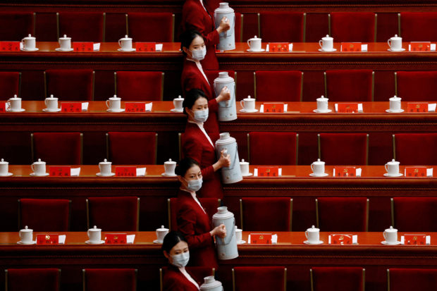 FILE PHOTO: Attendants serve tea for delegates before the opening ceremony of the 20th National Congress of the Communist Party of China, at the Great Hall of the People in Beijing, China October 16, 2022. REUTERS/Thomas Peter/File Photo