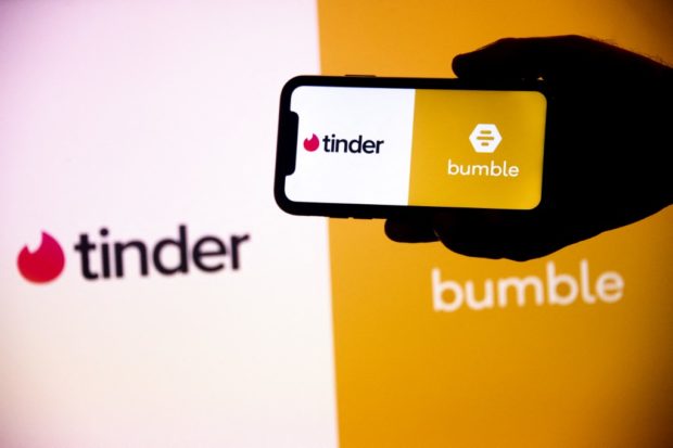This illustration picture shows the logos of the dating apps Tinder and Bumble displayed on a mobile phone and a desktop screen in Rio de Janeiro, Brazil, on October 7, 2022.