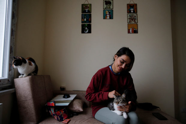 Mikaeil Alizadeh, also known by her stage name Leo, is pictured with her cats in Istanbul