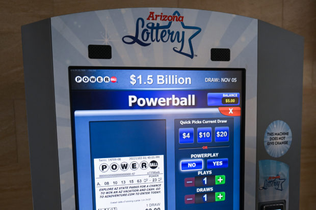 An Arizona Lottery kiosk displays lottery tickets ahead of a PowerBall $1.5 Billon jackpot at a kiosk inside the Phoenix Sky Harbor International Airport (PHX) in Phoenix, Arizona on November 3, 2022. (Photo by Patrick T. FALLON / AFP)