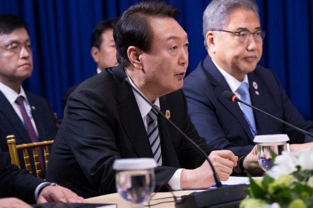South Korean President Yoon Suk-yeol (C) speaks during a trilateral meeting with US President Joe Biden and Japanese Prime Minister Fumio Kishida on the sidelines of the East Asia Summit during the 40th and 41st Association of Southeast Asian Nations (ASEAN) Summits in Phnom Penh on November 13, 2022. (Photo by SAUL LOEB / AFP)