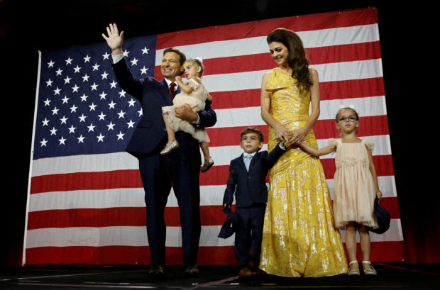 Republican Florida Governor Ron DeSantis waves from stage next to his wife Casey and children during his 2022 U.S. midterm elections night party in Tampa, Florida, U.S., November 8, 2022. REUTERS/Marco Bello