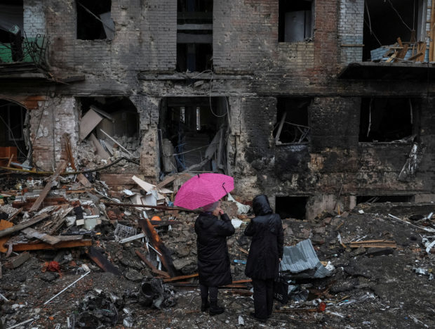 Local residents stand near their building destroyed by a Russian missile attack, as Russia's attack on Ukraine continues, in the town of Vyshhorod, near Kyiv, Ukraine November 24, 2022. REUTERS/Gleb Garanich
