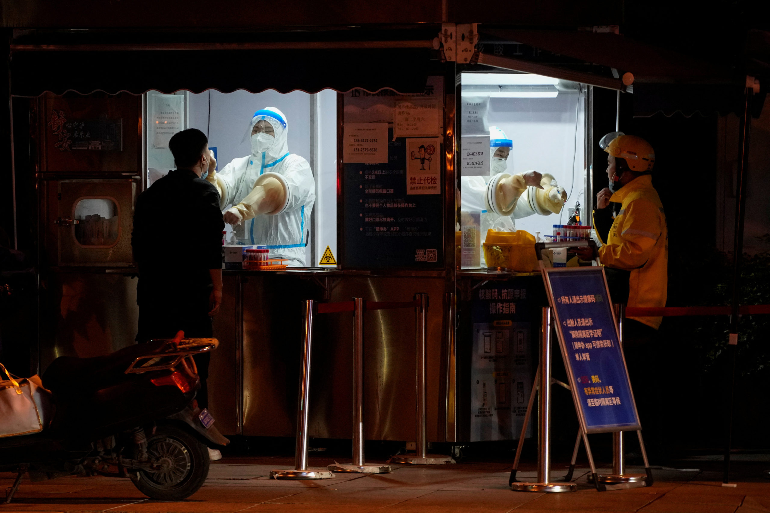 FILE PHOTO: People get tested at a nucleic acid testing site, following the coronavirus disease (COVID-19) outbreak in Shanghai, China, November 25, 2022. REUTERS/Aly Song China covid cases record