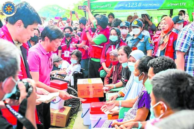 President Marcos leads the distribution of relief assistance to Paeng victims taking shelter at Broce Central Elementary School of Peace at Datu Odin Sinsuat, Maguindanao province, on Tuesday. STORY: Marcos at ground zero: Tree cutting to blame for landslides