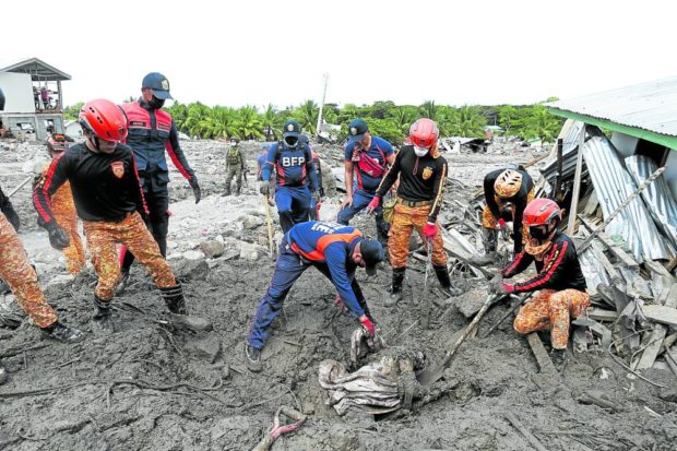 RETRIEVAL Rescuers, in this Oct. 30 photo, conduct a retrieval operation in Barangay Kusiong, Datu Odin Sinsuat, Maguindanao del Norte, to find Teduray tribe members buried in a landslide on Oct. 28 that occurred after days of rain spawned by Several Tropical Storm “Paeng” (international name: Nalgae). —JEOFFREY MAITEM