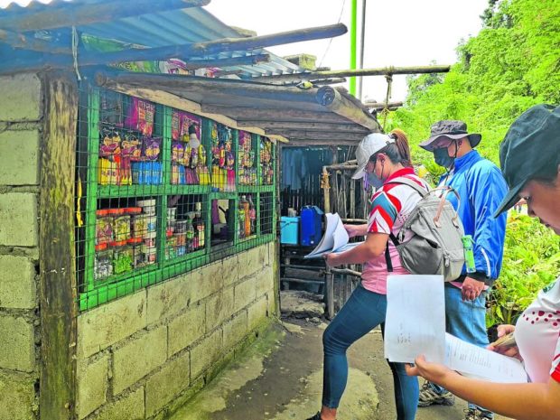 EXPLAIN Personnel from the Department of Environment and Natural Resources, in this photo taken on Nov. 3, deliver the show cause orders issued by the agency, asking occupants to explain their presence inside a “protected area” along the Marikina-Rizal-Laguna-Quezon Highway. —DEPARTMENT OF ENVIRONMENT AND NATURAL RESOURCES FACEBOOK PHOTO