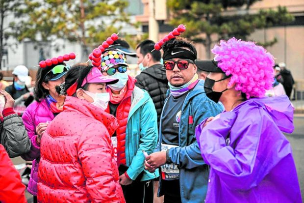 ON YOUR MARK Runners in colorful costumes prepare before the start of the Beijing Marathon in the Chinese capital on Nov. 6. —AFP