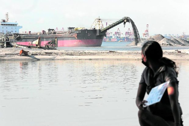 Reclamation barge at the Manila Bay coast. STORY: Geologist warns of hazards of living in reclaimed areas