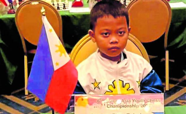 LITTLE CHAMP Bince Rafael Operiano, 9, bags the championship at the international chess competition Eastern Asia Youth Championship Standard Rapid Blitz (U-10) held in Bangkok, on Nov. 12. —PHOTO COURTESY OF BEN OPERIANO