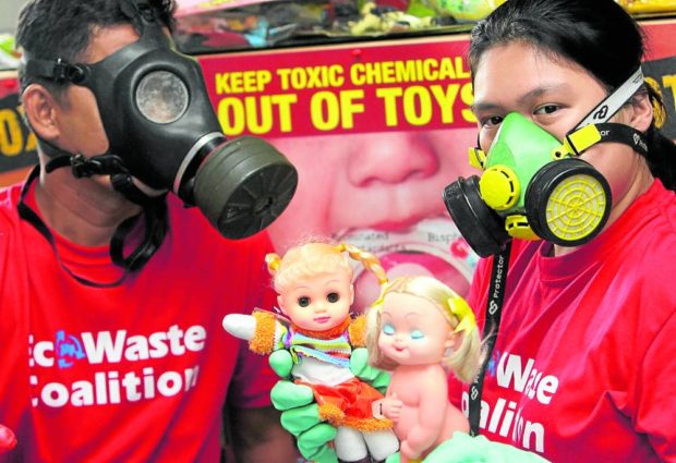 TOXIC TOYS A member of Ecowaste Coalition shows toys tested for hazardous and toxic substances like lead. —FILE PHOTO