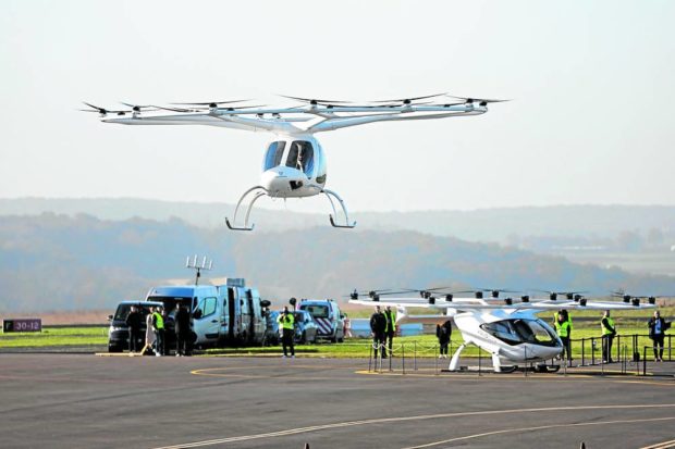 ‘EASIER TO FLY’ A Volocopter 2X drone taxi takes off at Pontoise airfield in Cormeilles-en-Vexin, outside Paris, on Thursday. —REUTERS