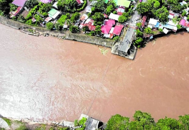 GONE Only the approaches of the collapsed 63-linear meter Bantilan Bridge that used to connect Barangay Tipas in San Juan, Batangas, and Barangay Manggalang Bantilan in Sariaya, Quezon, remain. Raging river current due to intense rains spawned by Severe Tropical Storm “Paeng” (Nalgae) destroyed the structure on Oct. 29. —PHOTO COURTESY OF THE SARIAYA PUBLIC INFORMATION OFFICE