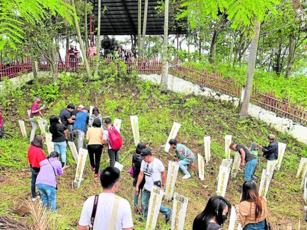 CLEANUP Families and friends of media workers slain in the infamous Nov. 23, 2009, Ampatuan massacre visit their gravesites at Sitio Masalay, Barangay Salman, Ampatuan town, of the now Maguindanao del Sur province on Sunday, to remember and continue their quest for justice. —JONATHAN DE SANTOS/contributor