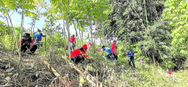 SUSTAINING WATERSHED Agrarian reform officials in Cotabato province along with local environment personnel plant trees around Asik-Asik Falls, Alamada town’s top tourist destination, to sustain its watershed. —PHOTO COURTESY OF DEPARTMENT OF AGRARIAN REFORM COTABATO 