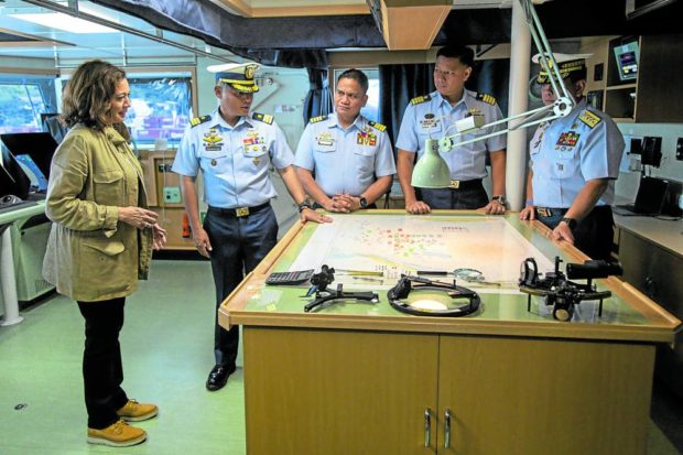 LOOKING AT THE MAP Harris is briefed by members of the Philippine Coast Guard at the BRP Teresa Magbanua, docked at Puerto Princesa City on Thursday. —REUTERS