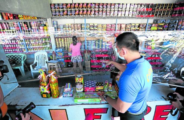 A team from the Department of Trade and Industry and policemen inspect stores at Barangay Turo in Bocaue, Bulacan, in this photo taken on Dec. 28, 2020. STORY: Firecracker makers seek control on online selling