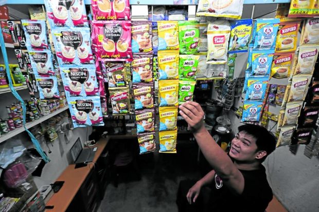 COMMON SIGHT  A storekeeper arranges different brands of drinks in sachets at a “sari-sari” store in Quezon City.  —GRIG C. MONTEGRANDE