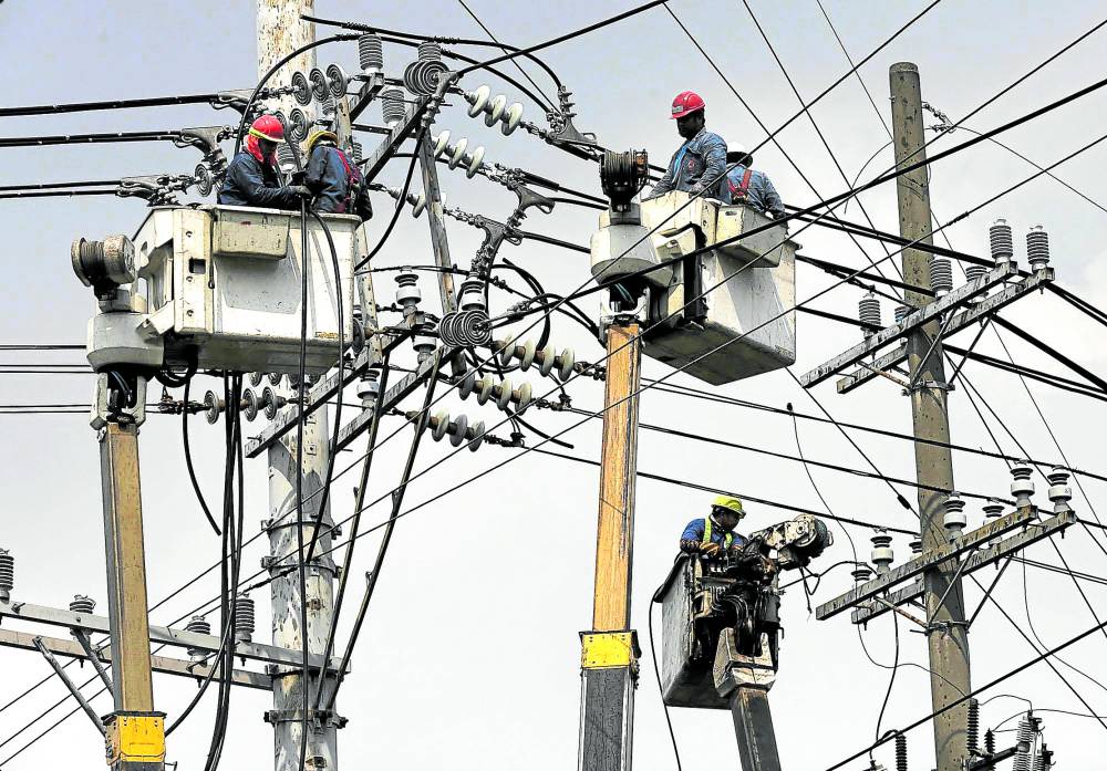CABLE WORK Linemen replace cables on electric posts on UN Avenue in Manila in this photo taken on June 19. The country’s grid operator on Monday warned of insufficient power supply in Luzon due to the tripping of several power plants. —RICHARD A. REYES