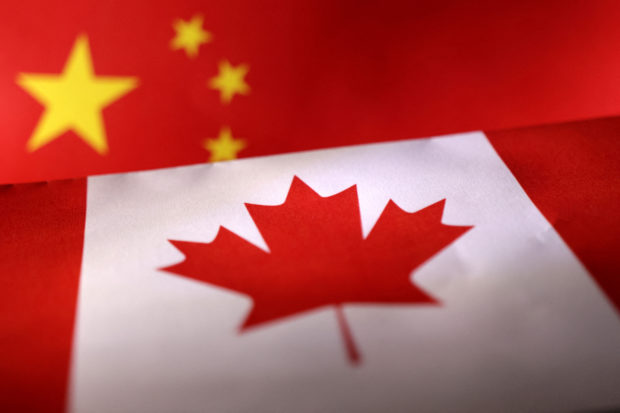 FILE PHOTO: Illustration shows printed Chinese and Canada flags