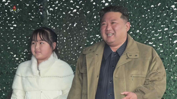 North Korean leader Kim Jong-un stands with his daughter