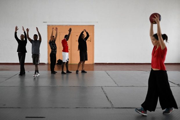 Inmates attend a contemporary dance class at Linho prison in Alcabideche, near Cascais on October 31, 2022. - 16 inmates from Linho Prison take part in the project which started in May 2019, developed by Catarina Camara, a 42 years old dancer of Companhia Olga Roriz, trained in Gestalt therapy. (Photo by PATRICIA DE MELO MOREIRA / AFP)