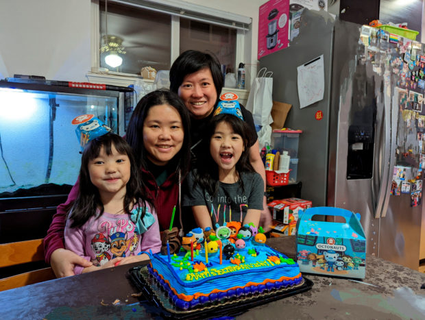 Same-sex parents Olivia and Irene pose with daughters Zoey and Vicky during a birthday celebration in Seattle