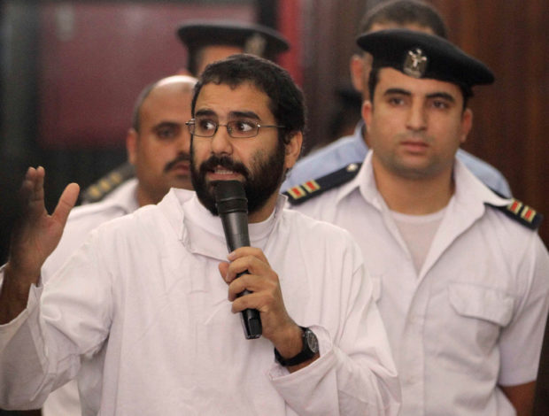 FILE PHOTO: Activist Alaa Abd el-Fattah speaks in front of a judge at a court during his trial in Cairo