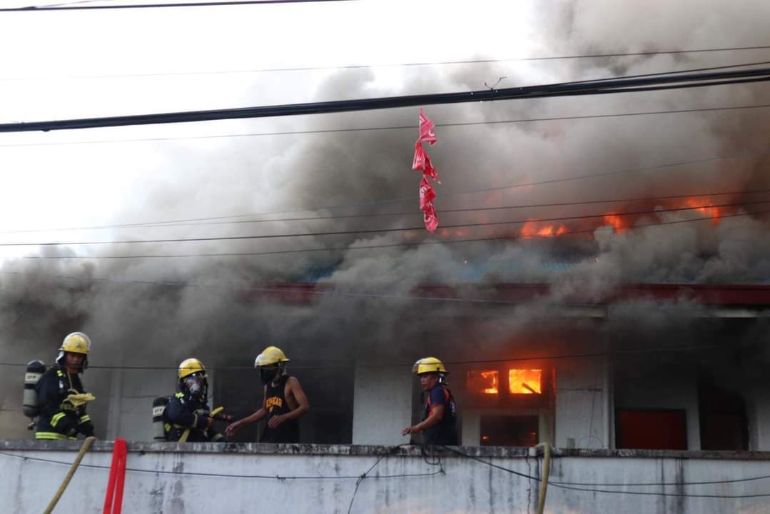 RAGING FIRE. Firemen come dangerously close to the raging fire that gutted the offices on the second floor of the town hall of Sto. Domingo, Albay on Sunday afternoon, Nov. 13. The incident was declared "fire out" at 7 p.m. Photo by Sto. Domingo Mayor Joseling Aguas Jr.