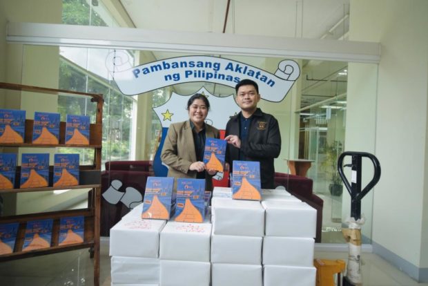 Anna Mae Yu Lamentillo and Cesar Gilbert Adriano. STORY: Lamentillo donates copies of her ‘Night Owl’ book to National Library