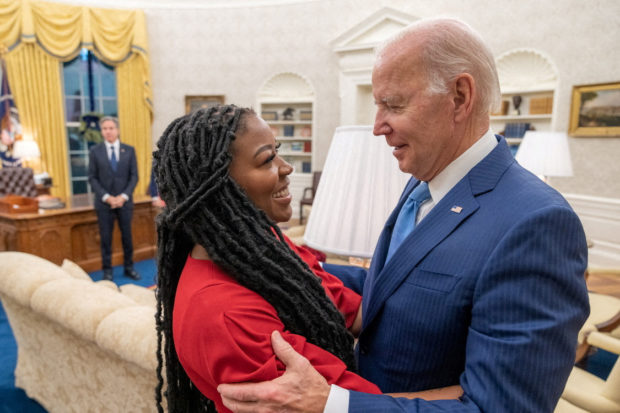 U.S. President Joe Biden is seen hugging Cherelle Griner in this White House handout photo taken in the Oval Office, after the release of her wife, WNBA basketball star Brittney Griner by Russia, as U.S. Secretary of State Antony Blinken looks on at the White House in Washington, U.S. December 8, 2022. The White House/Handout via REUTERS