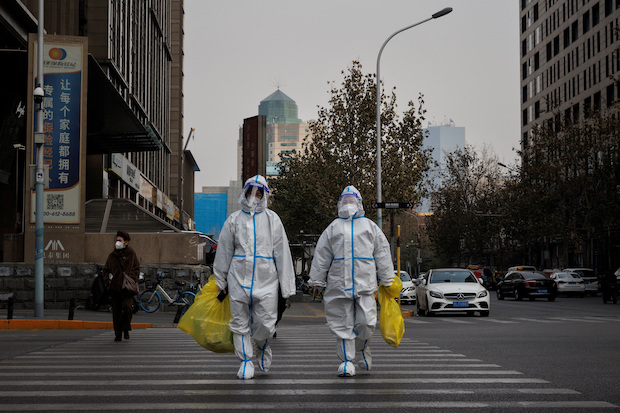 Pandemic prevention workers in protective suits. STORY: ‘It's dead out here’: China's slow exit from ‘zero-COVID’ policy