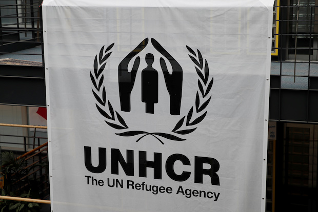 A logo is pictured on a banner at the UNHCR headquarters in Geneva. STORY: At least 180 Rohingya feared dead - UN refugee agency